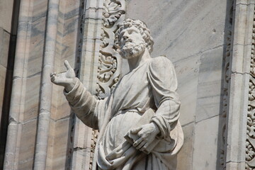 Detail of a sculpture carved on white marble on the facade of the Cathedral of Milan (Italy)
