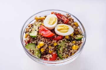 bowl of healthy quinoa with vegetables on a white background