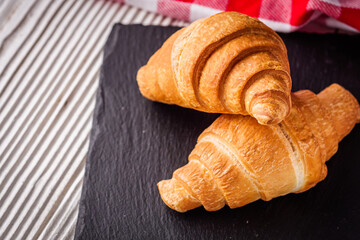 delicious fresh croissant on a white wooden rustic background