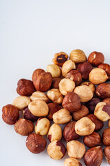 fresh natural hazelnuts on a white acrylic background
