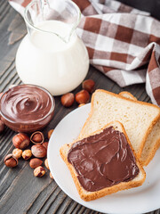 toasts with chocolate butter on a dark wooden rustic background