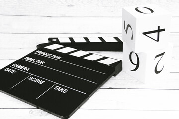 Fototapeta na wymiar Clapper board and cubes with numbers
