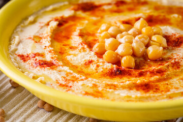 traditional turkish hummus on a white wooden rustic background