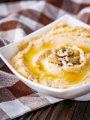 traditional turkish hummus on a dark wooden rustic background