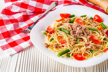 delicious traditional Italian pasta with tuna on a white rustic wooden background