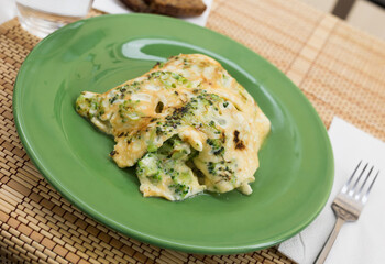 wholesome breakfast. omelet with broccoli on green plate