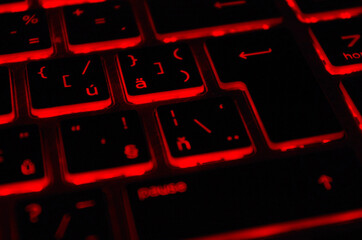 Modern red iluminated backlit keyboard. Red backlight, backlit on laptop or keyborad computer of...