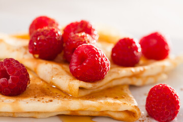 delicious  pancakes with fresh raspberries and honey