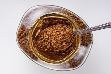 instant coffee granules on a white acrylic background