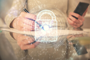 Double exposure of lock sketch hologram and woman holding and using a mobile device. Security iT concept