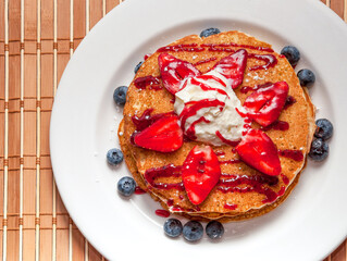 Pancakes with ice-cream and strawberries