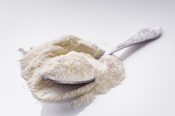 granulated milk powder on a white acrylic background