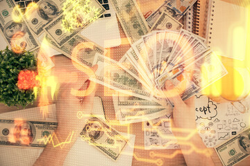 Multi exposure of seo drawing hologram and us dollars bills and man hands.