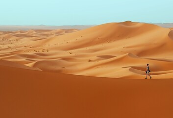 Man walking in desert on duna edge