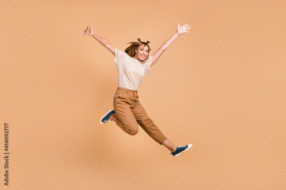 Sticker Full length photo of girl jump having fun wear t-shirt pants sneakers isolated beige color background