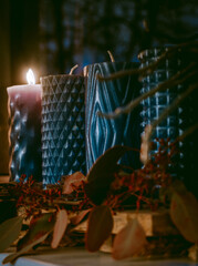 Modern Advent wreath or crown on a wooden plank with dried plants and four blue candles