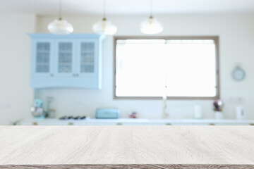 empty table board and defocused modern kitchen background. product display concept