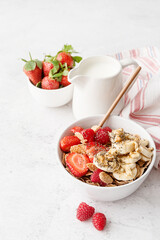 Healthy breakfast, cereal, fresh berries and milk in a bowl