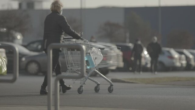 People push shopping cart in front of the store.