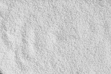 Pellets of ammonium nitrate as background, top view. Mineral fertilizer