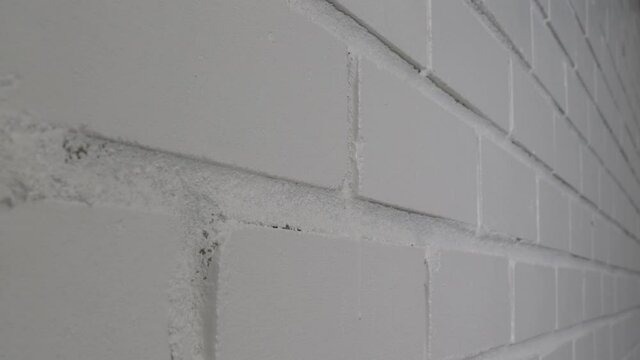 White brick wall in camera motion shot in close up