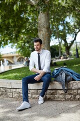Fototapeta premium Young businessman resting at park.