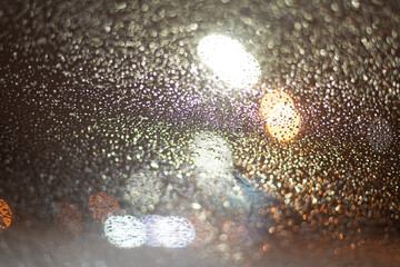 Blurred background with raindrops and lights.