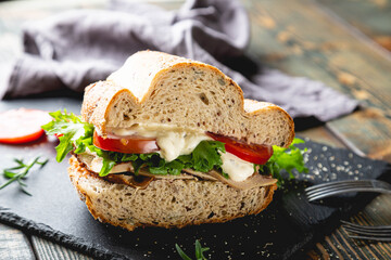 Large sandwich with turkey, vegetables and whole grain bread