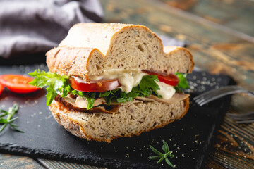 Large sandwich with turkey, vegetables and whole grain bread