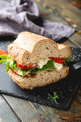 Large sandwich with turkey, vegetables and whole grain bread
