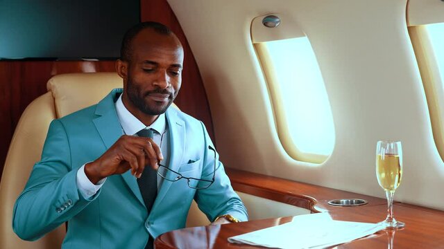 Successful entrepreneur toasting with champagne on his private jet