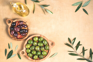 Fototapeta na wymiar Mediterranean background with pickled olives for the for tapas or antipasti in olive trees bowls on the warm color table, top view, copy space 