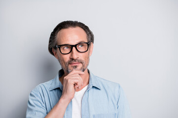 Photo of mature handsome man dream dreamy think wonder idea look empty space isolated over grey...