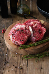 Raw meat on wooden board with dark background