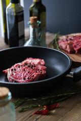 Raw meat on wooden board with dark background