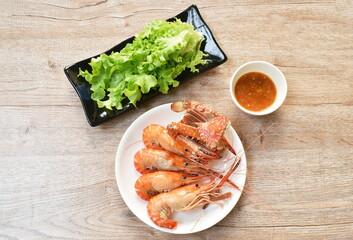 steamed shrimp and cutting flower crab on plate eat with fresh vegetable dipping spicy and sour sauce