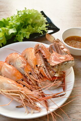 steamed shrimp and cutting flower crab on plate eat with fresh vegetable dipping spicy and sour sauce