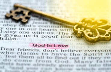 an old key on top of an old Bible