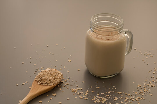 Oatmeal drink with flakes on table