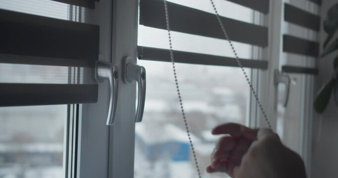 Man installing cassette roller blinds on windows