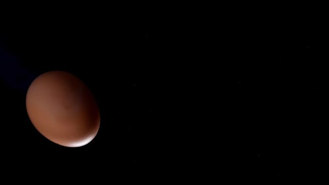 Egg is spinning on a black background. Slow motion of an egg in a shell spinning on glass. Close shot of a spinning egg.