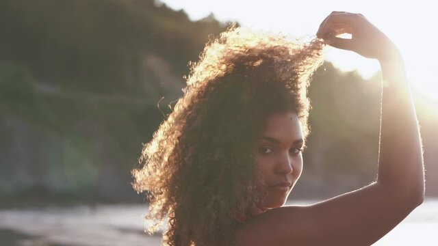 Beautiful young woman laughing happily on the beach