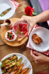 Enjoying dinner woman eat, drink lemonade, dinner table