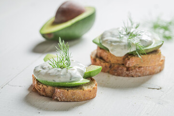 Sandwich with avocado, dill and tzatziki sauce