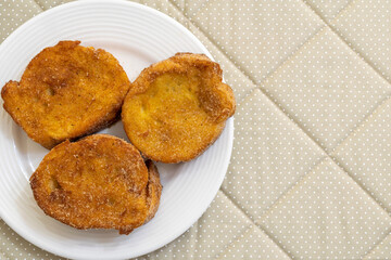 baked or fried bread with sugar and cinnamon. Dessert called Rabanada, Torrija or golden bread. cuisine from Brazil, Portugal and Spain. view from the top. space to tezxt