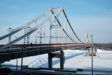 Fototapeta na wymiar Pedestrian bridge in winter in Kyiv.
