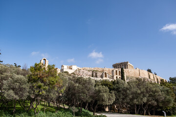 Fototapeta na wymiar Acropolis of Athens Greece rock and Parthenon on blue sky background, sunny day.
