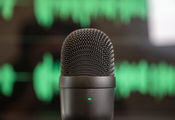 Black condenser microphone, mike blur green waveform background.