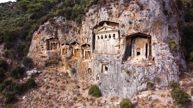 Aerial is flying backwards from Caunos Tombs of the Kings
