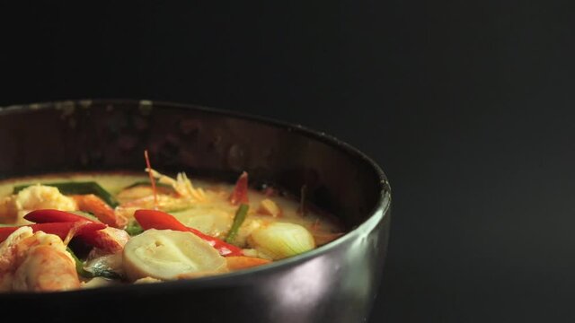Tom Yum Goong Soup With Shrimps On Bowl Spinning - Thai Chinese Soup. - close up, studio